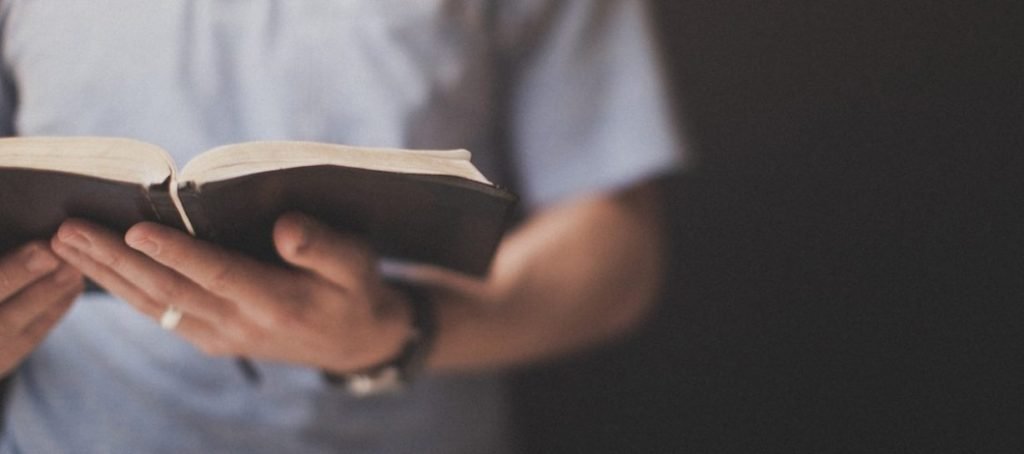 holding-bible-1263x560-1024x454